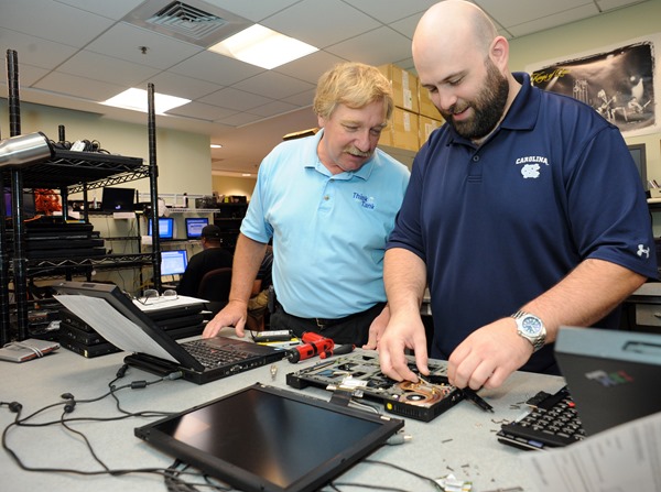 Linwood Furelle, left, chats with Kevin Lawrence, lead technician at the CCI computer repair center.