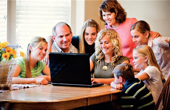 family-gathered-around-computer-415814-wallpaper-custom