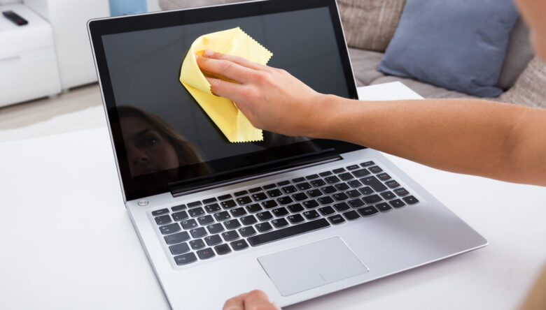 cleaning laptop screen with microfiber cloth